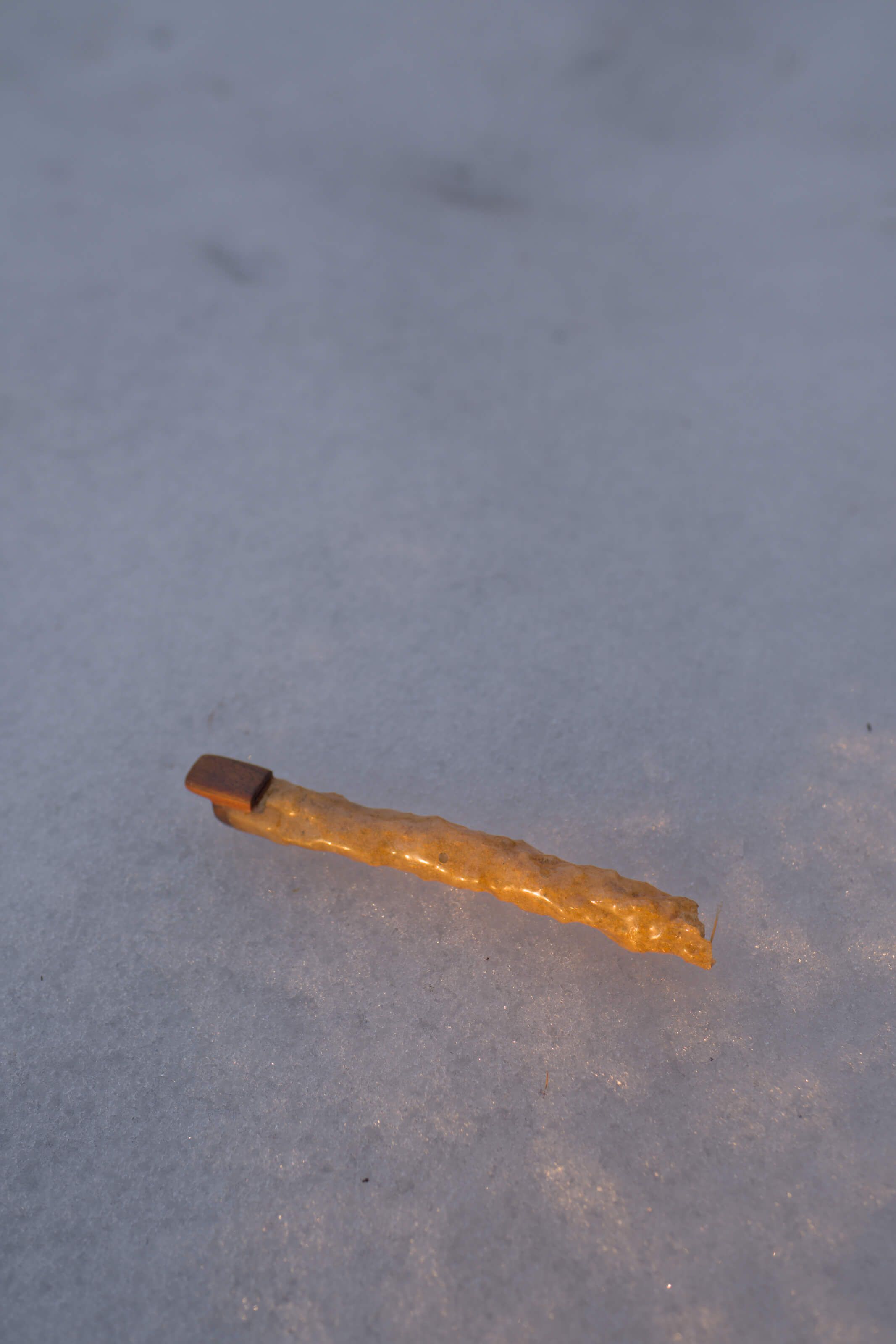 Fulgurite flute held in playing position, highlighting its unique sculptural form