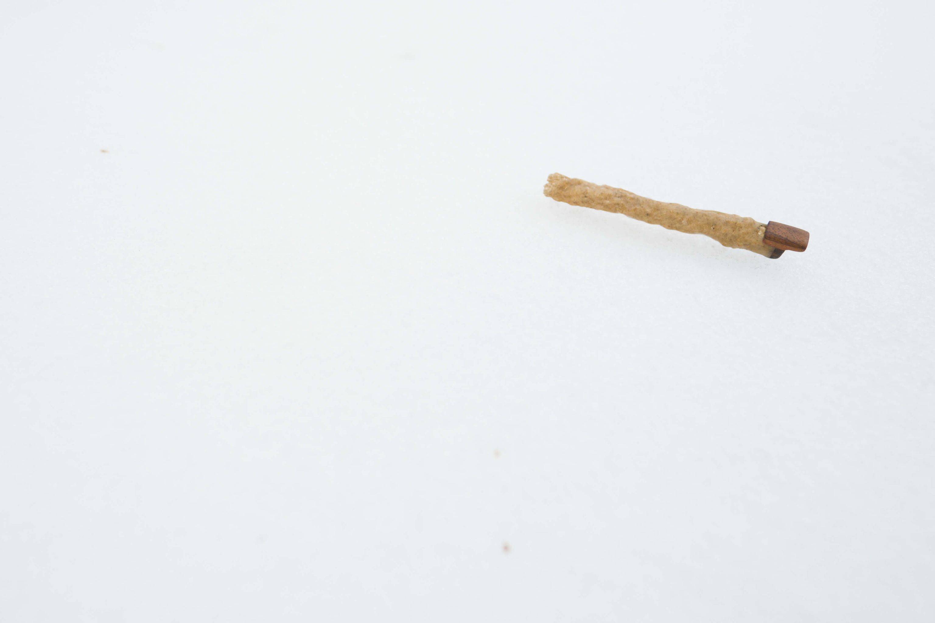 Close-up of a handcrafted fulgurite flute showing the natural texture of the lightning-fused mineral